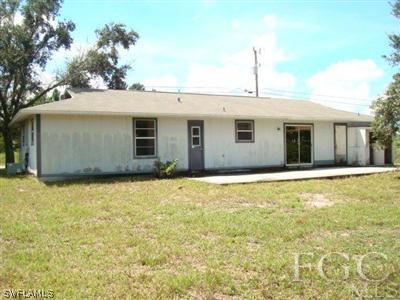 4204 9th Street Southwest Lehigh Acres, FL 33976 - Photo 10 of 10 a view of a house with a backyard