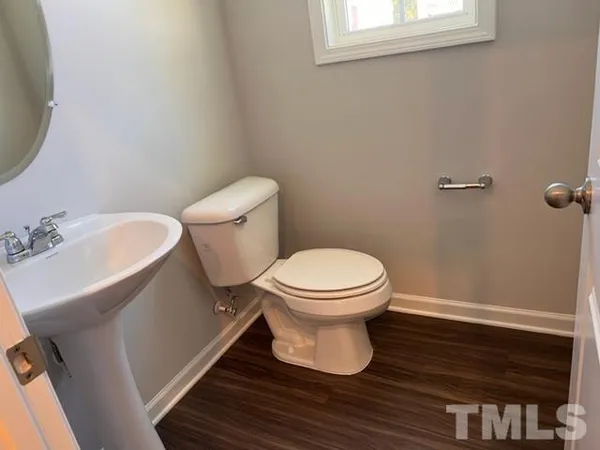 a white toilet sitting next to a bathroom sink