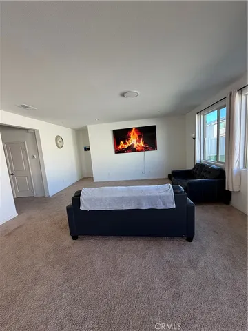 a spacious bedroom with a bed and a couch