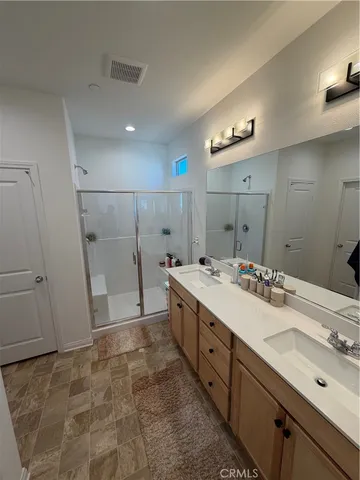 a bathroom with a double vanity sink and mirror