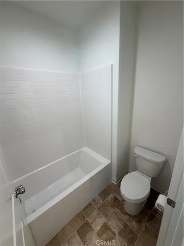 a bathroom with a toilet and a bathtub