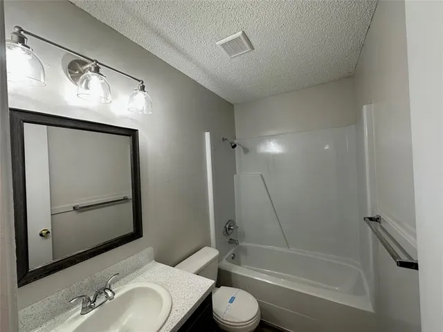 a bathroom with a toilet sink and a mirror
