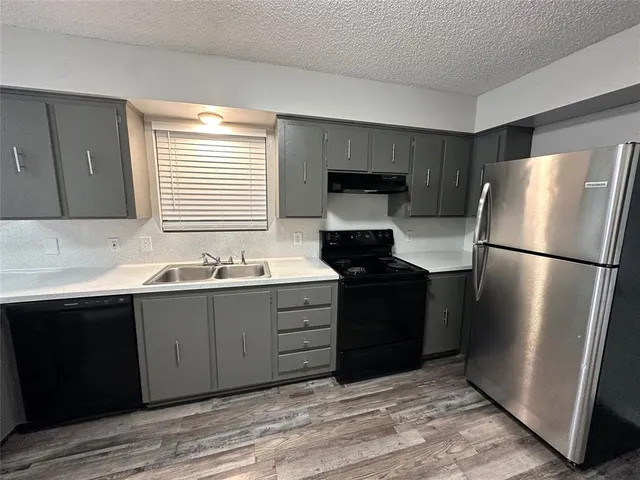 a kitchen with a refrigerator and a sink