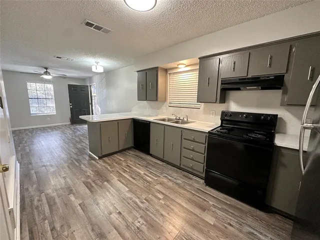 a kitchen with stainless steel appliances granite countertop a stove and a sink