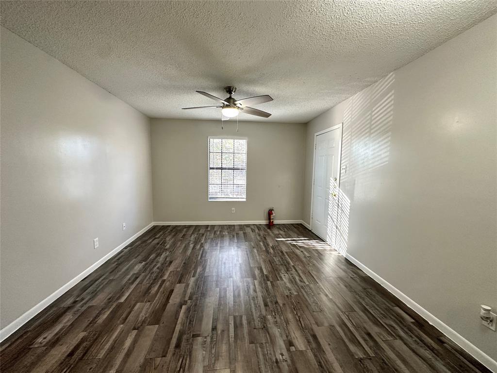 2006 Jane Street, Unit D Longview, TX 75601 - Photo 5 of 12 wooden floor in an empty room with a window