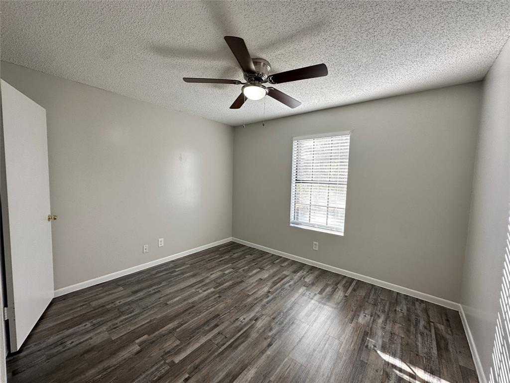 2006 Jane Street, Unit D Longview, TX 75601 - Photo 7 of 12 wooden floor in an empty room with a window