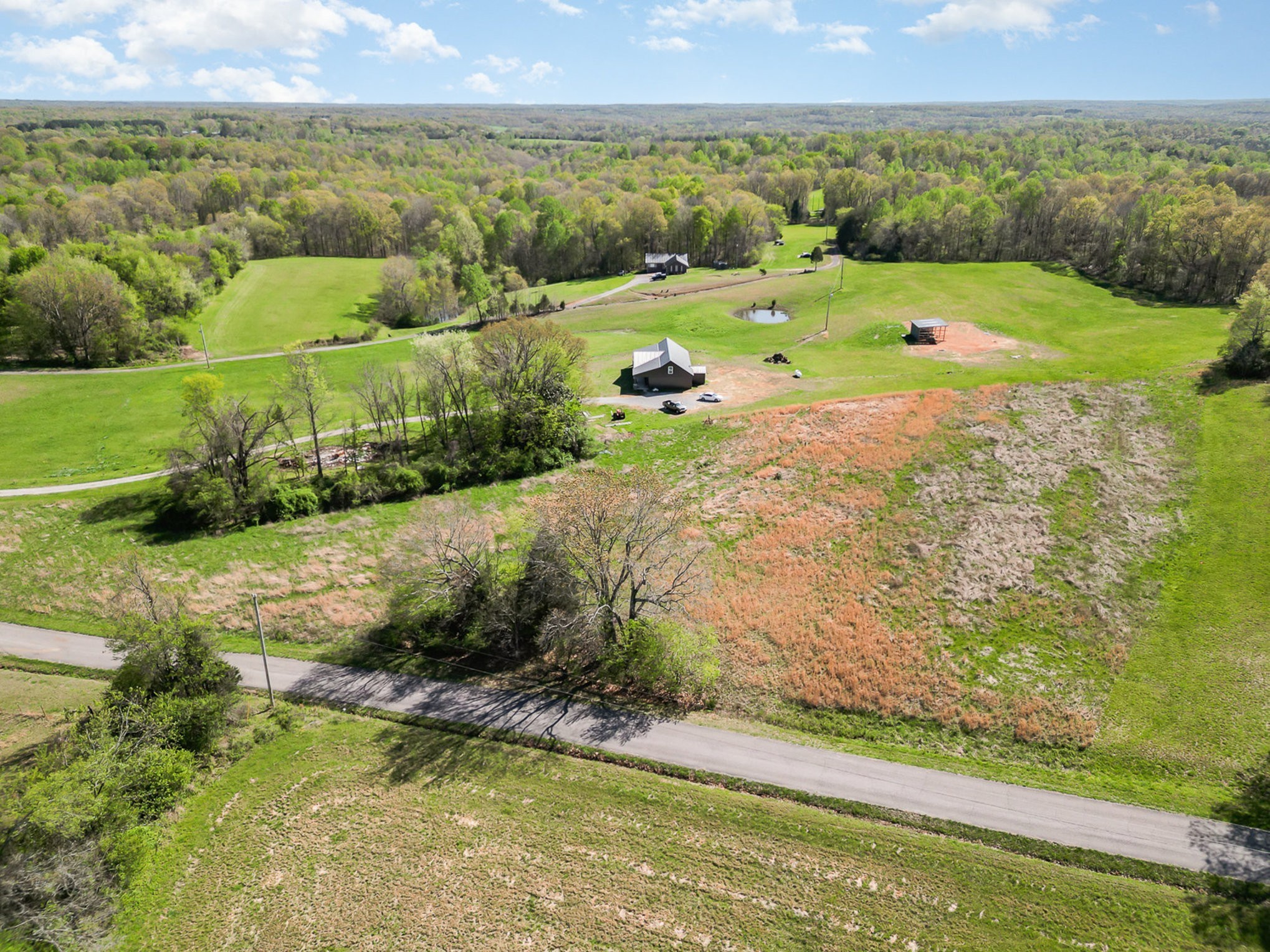 3 Batson Mill Road Charlotte, TN 37036 - Photo 2 of 4 a view of a lake with a big yard