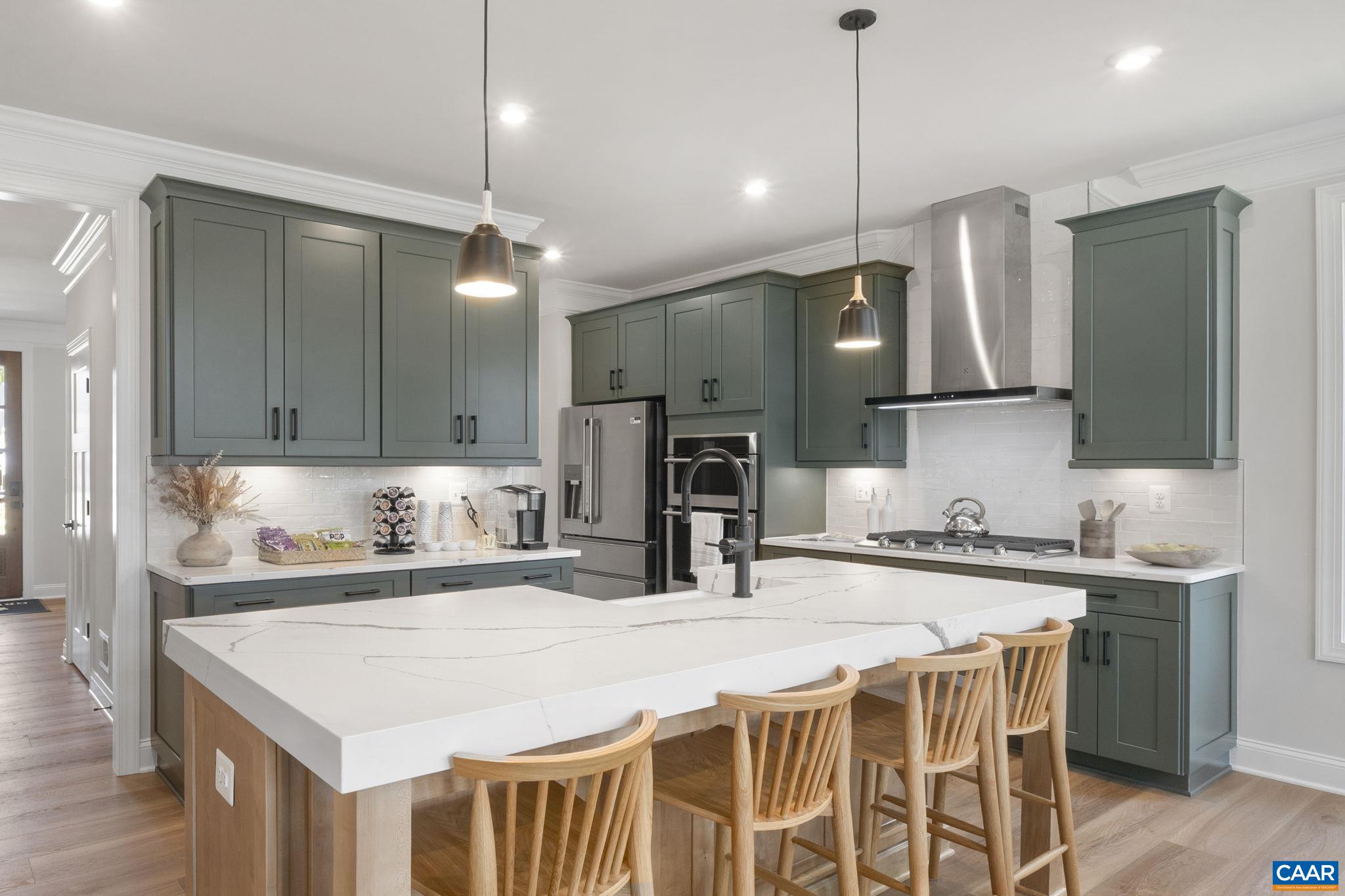 109 Marcella Street Charlottesville, VA 22911 - Photo 15 of 49 a kitchen with a sink a center island cabinets and stainless steel appliances