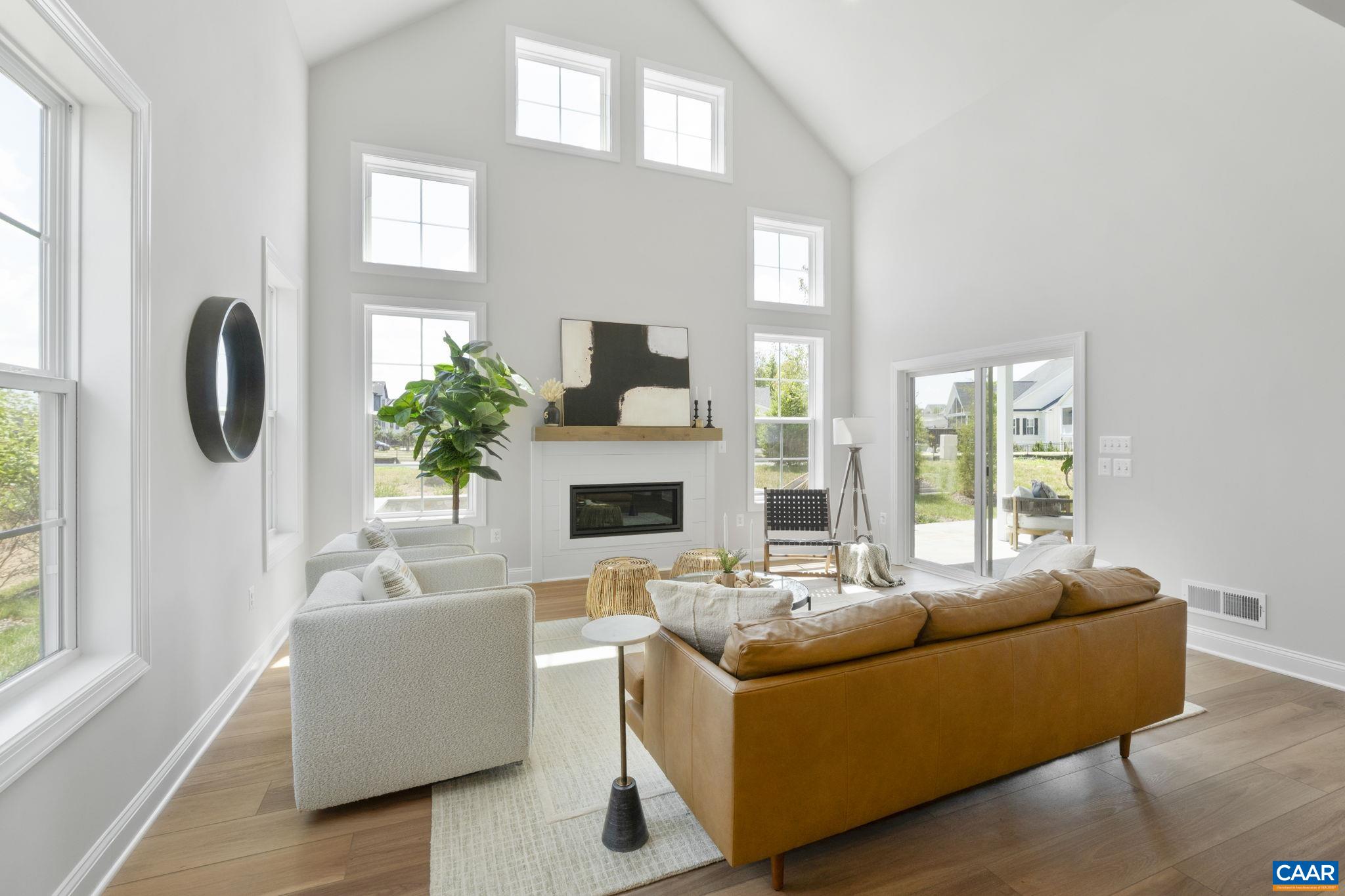 109 Marcella Street Charlottesville, VA 22911 - Photo 20 of 49 a living room with furniture a fireplace and a large window