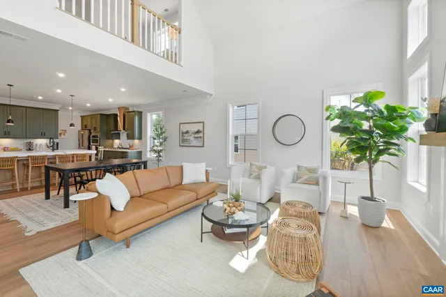 a living room with furniture potted plant and a window