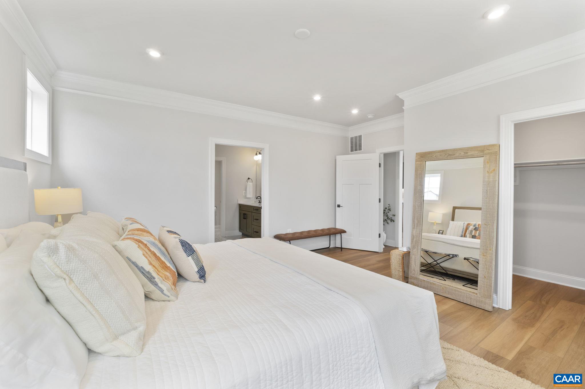 109 Marcella Street Charlottesville, VA 22911 - Photo 24 of 49 a spacious bedroom with a bed and a large mirror