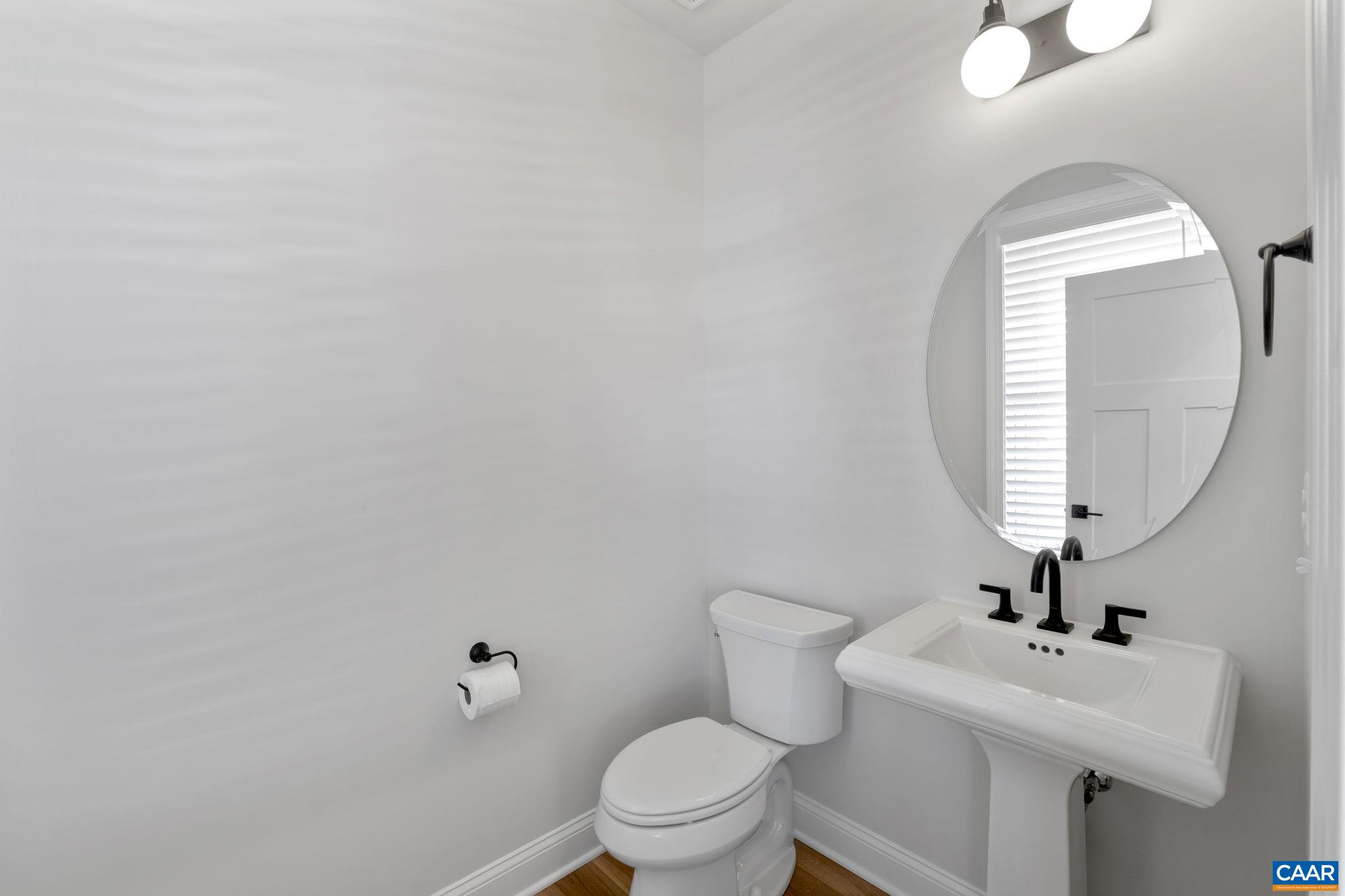 109 Marcella Street Charlottesville, VA 22911 - Photo 8 of 49 a bathroom with a toilet a sink and mirror