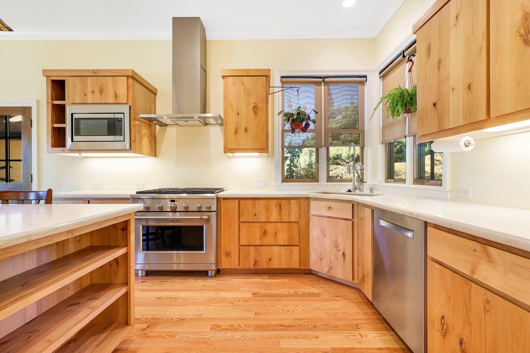 3211 Lake Redding Drive Redding, CA 96003 - Photo 14 of 68 a kitchen with stainless steel appliances granite countertop a stove and a sink