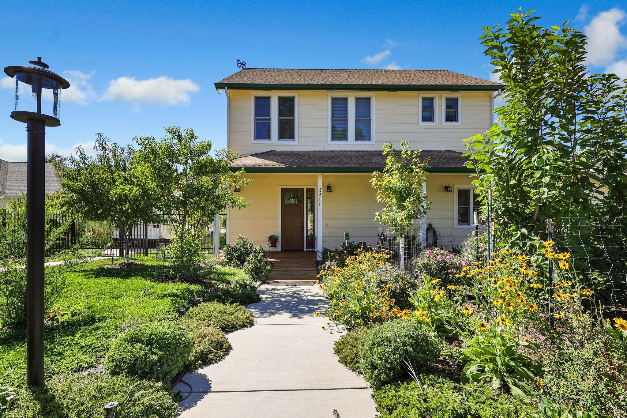 3211 Lake Redding Drive Redding, CA 96003 - Photo 2 of 68 a front view of a house with a yard and potted plants