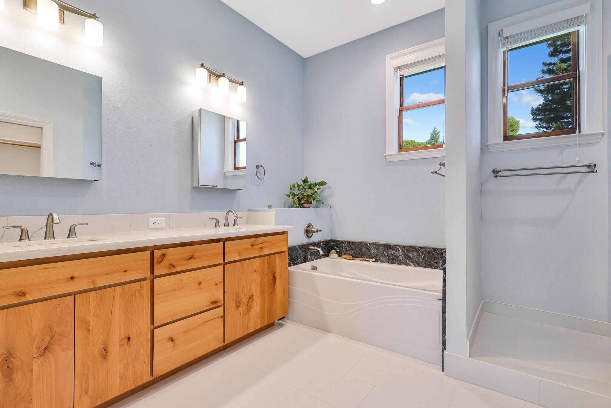 3211 Lake Redding Drive Redding, CA 96003 - Photo 21 of 68 a bathroom with a tub a sink and mirror