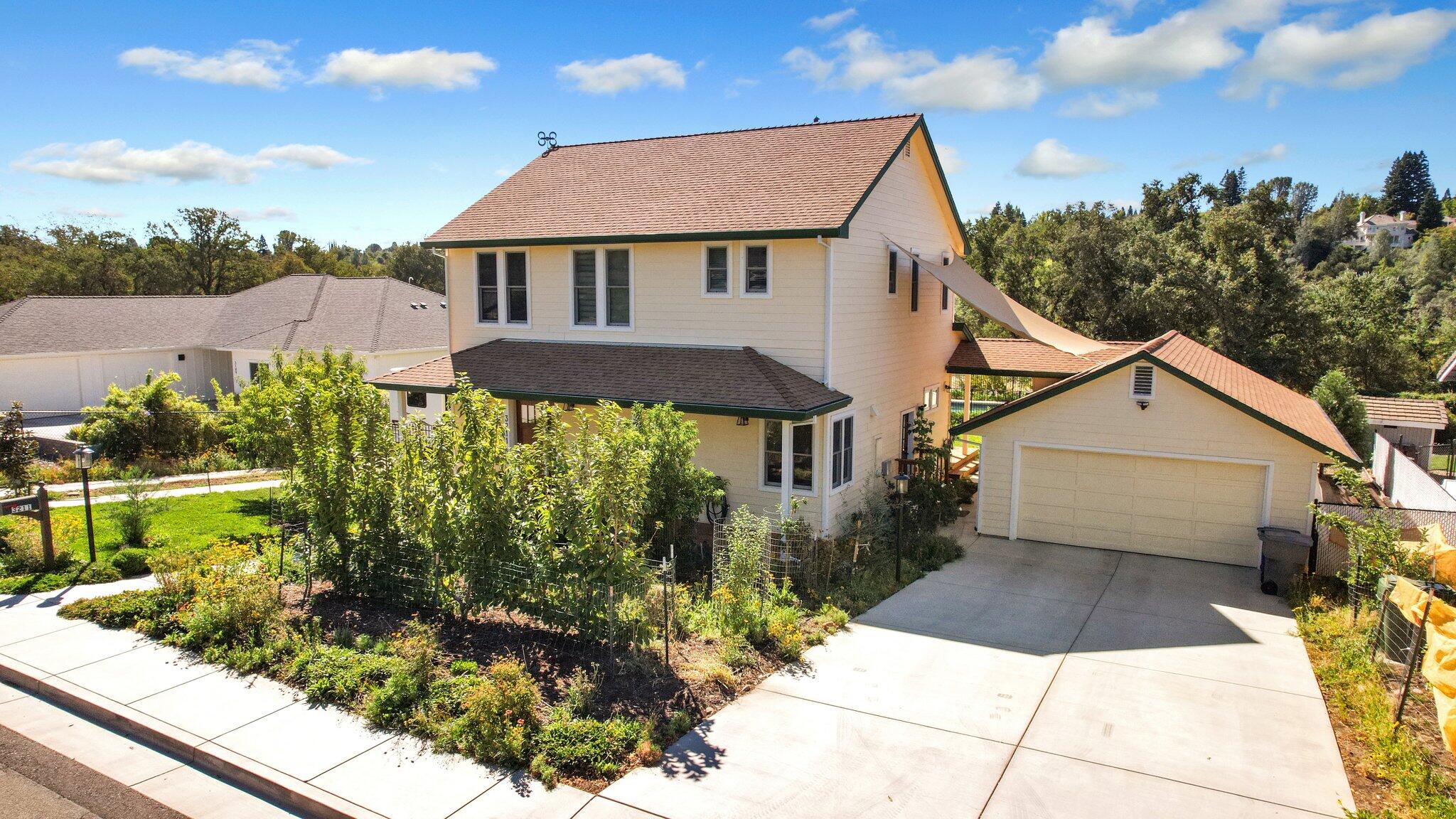 3211 Lake Redding Drive Redding, CA 96003 - Photo 3 of 68 a view of a white house next to a yard with potted plants