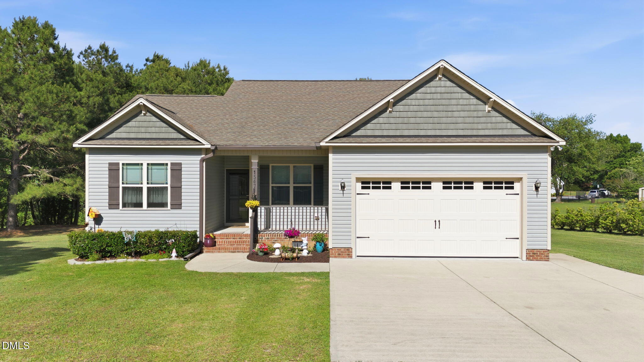 1547 Lassiter Pond Road Four Oaks, NC 27524 - Photo 2 of 45 a front view of a house with a yard and garage
