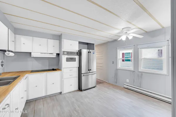 a kitchen with stainless steel appliances granite countertop a refrigerator and a stove top oven