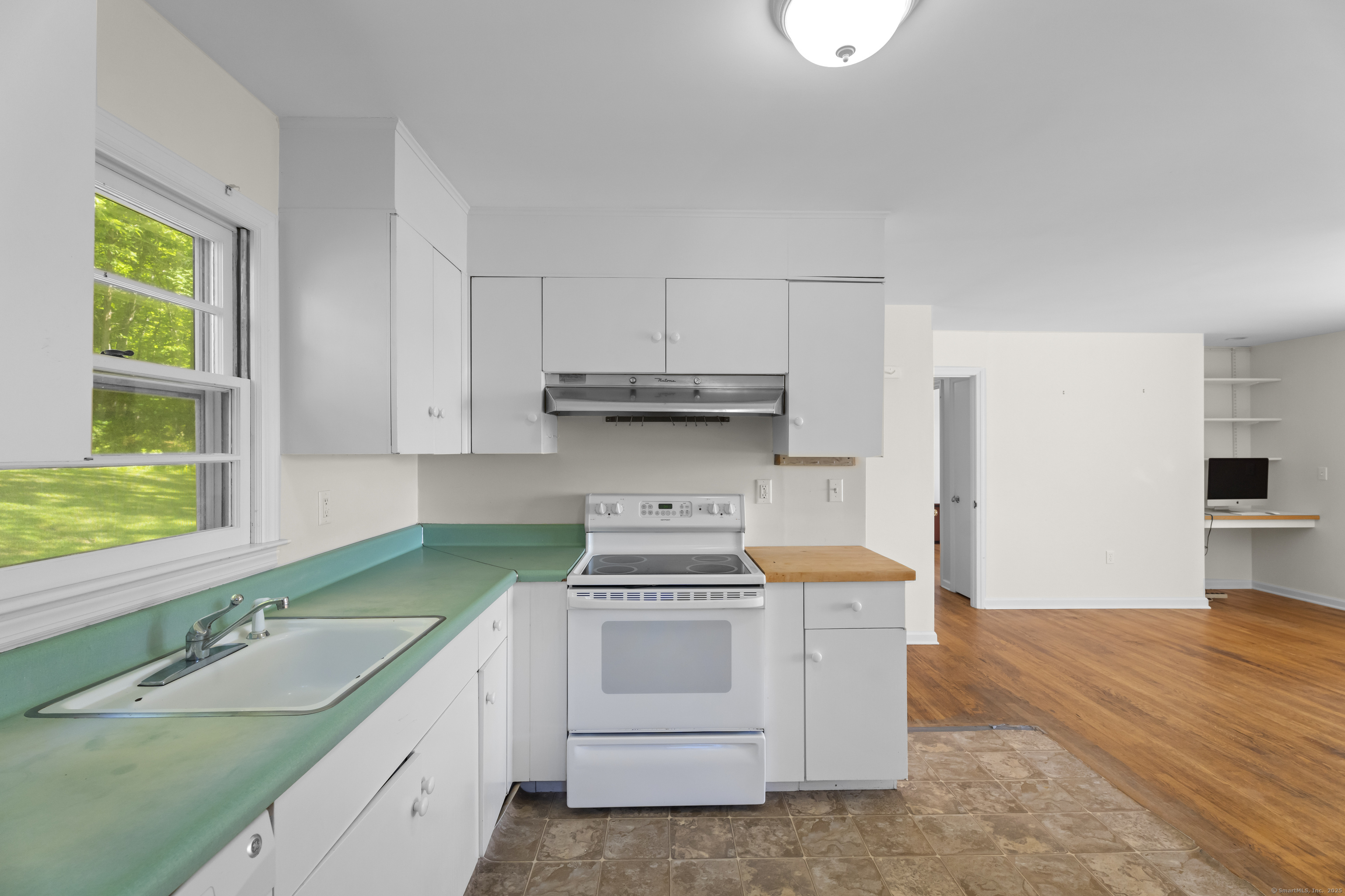 301 Osbrook Point Stonington, CT 06379 - Photo 12 of 39 a kitchen with granite countertop a stove sink and cabinets