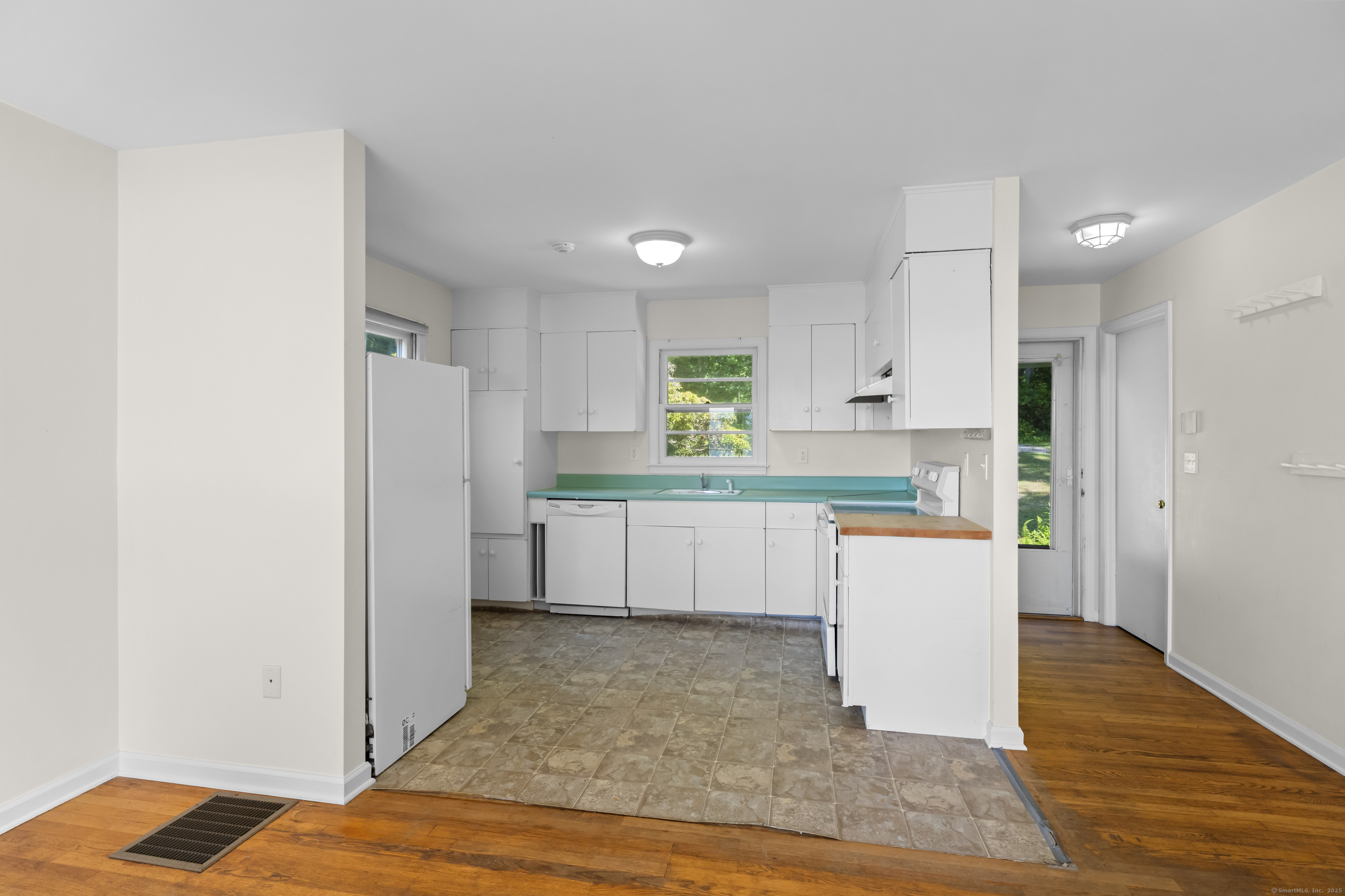 301 Osbrook Point Stonington, CT 06379 - Photo 13 of 39 a kitchen with white cabinets and counter space