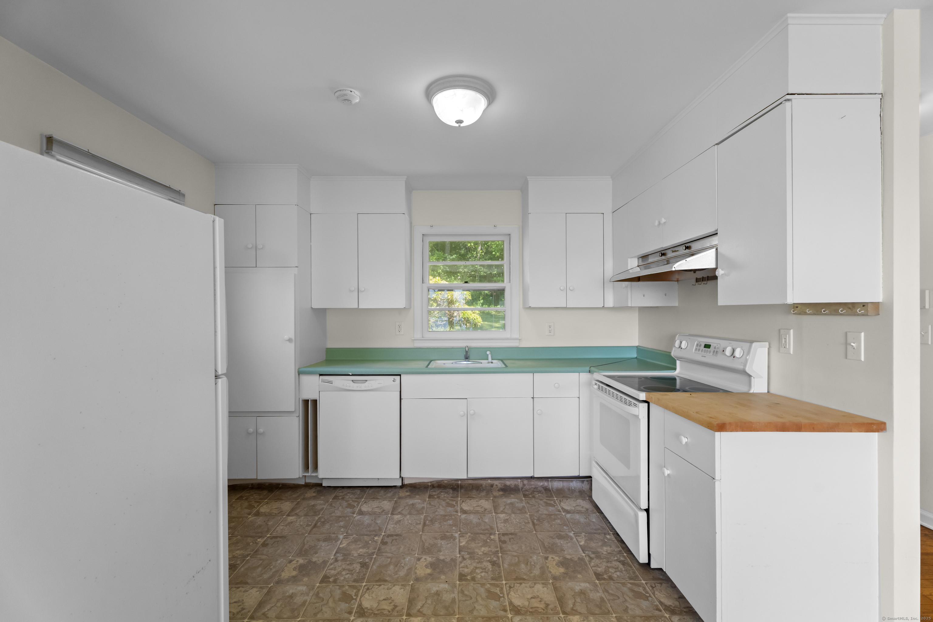 301 Osbrook Point Stonington, CT 06379 - Photo 15 of 39 a kitchen with a sink cabinets and window