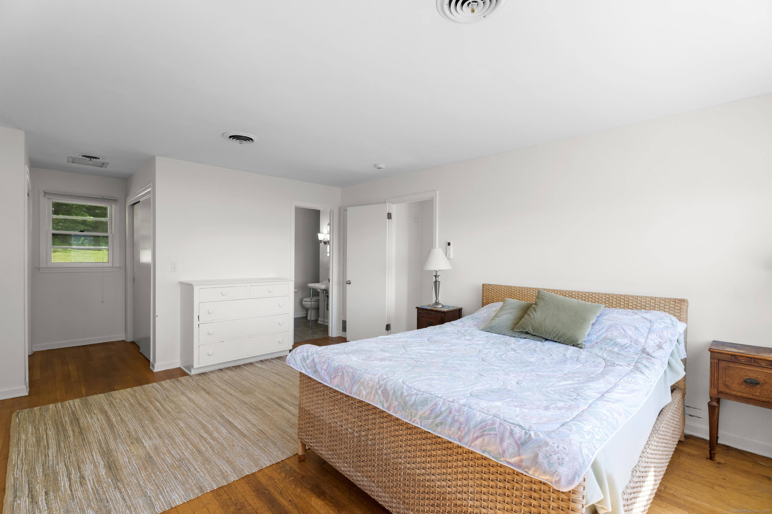 301 Osbrook Point Stonington, CT 06379 - Photo 17 of 39 a bedroom with a bed and wooden floor