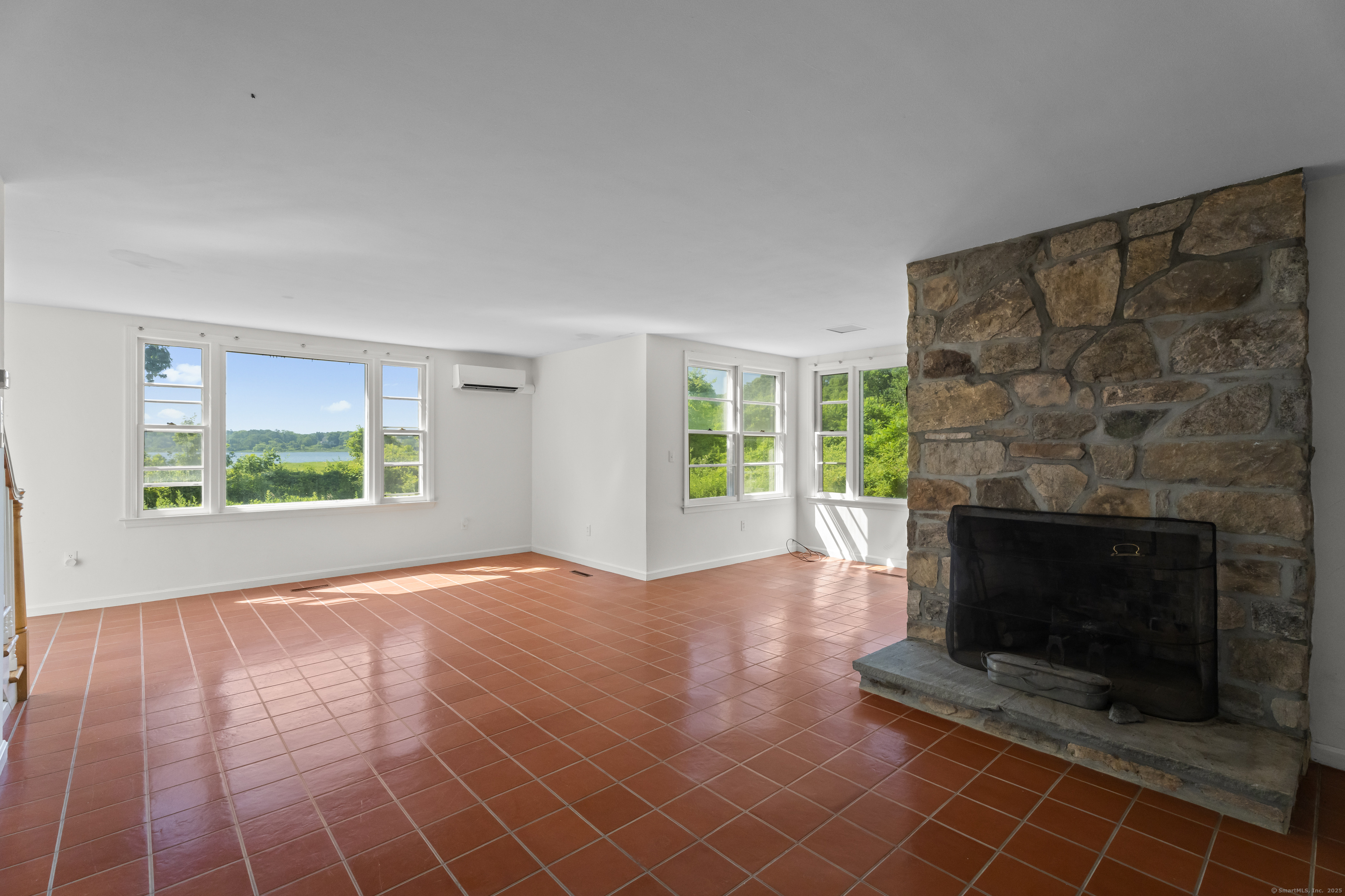 301 Osbrook Point Stonington, CT 06379 - Photo 19 of 39 a view of empty room with wooden floor and fireplace