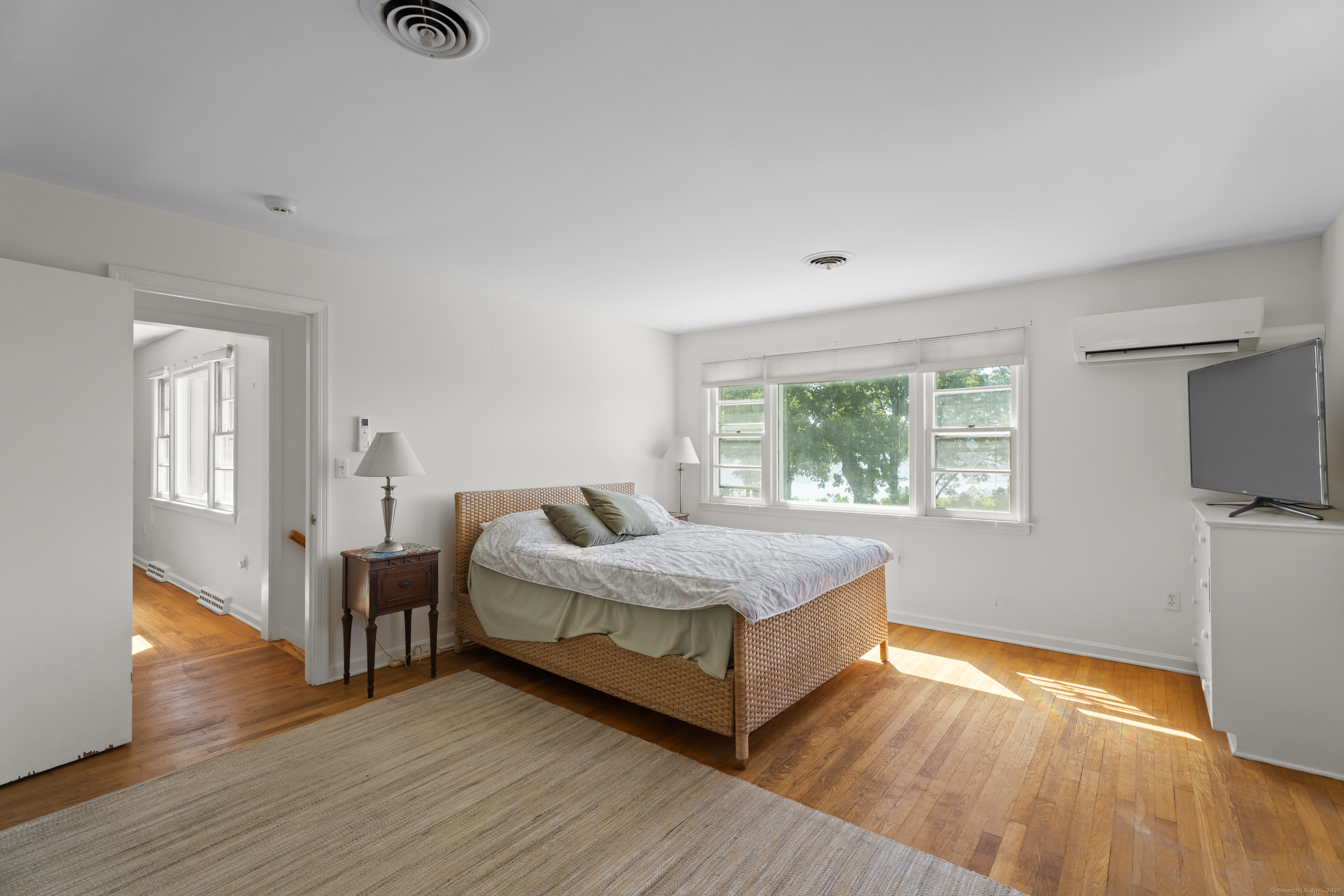 301 Osbrook Point Stonington, CT 06379 - Photo 20 of 39 a spacious bedroom with a bed and a window
