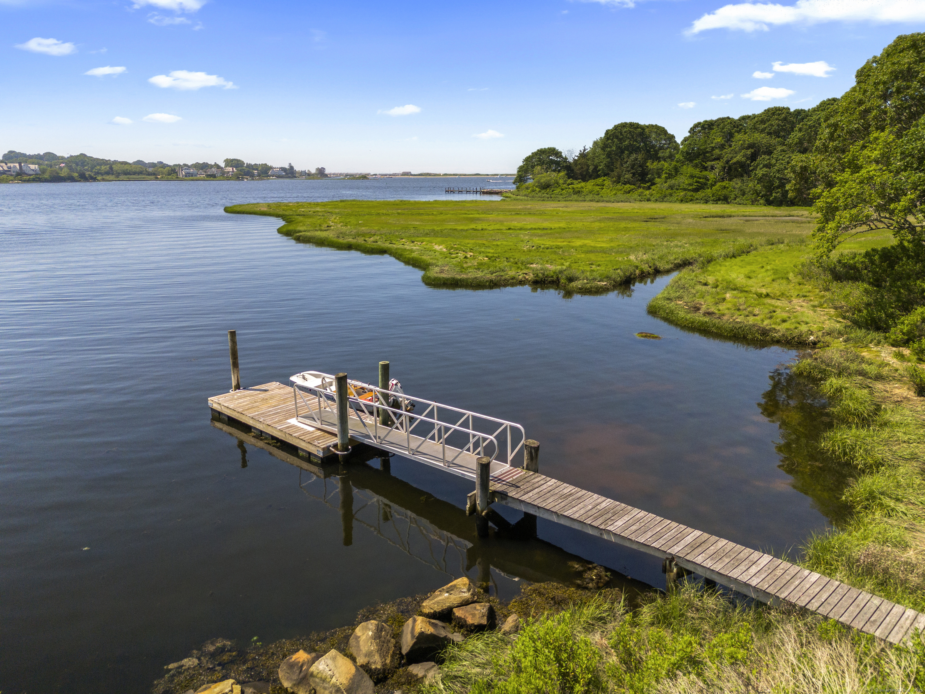 301 Osbrook Point Stonington, CT 06379 - Photo 2 of 39 a view of a lake with a yard