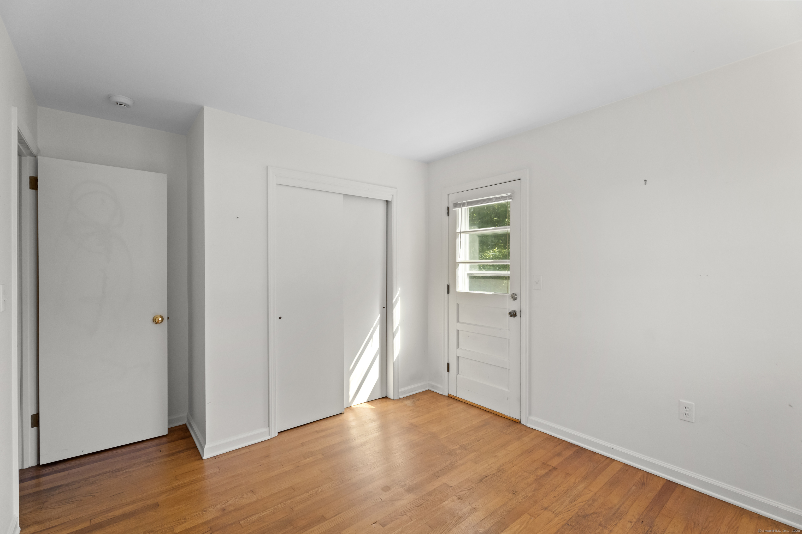 301 Osbrook Point Stonington, CT 06379 - Photo 22 of 39 an empty room with wooden floor and windows