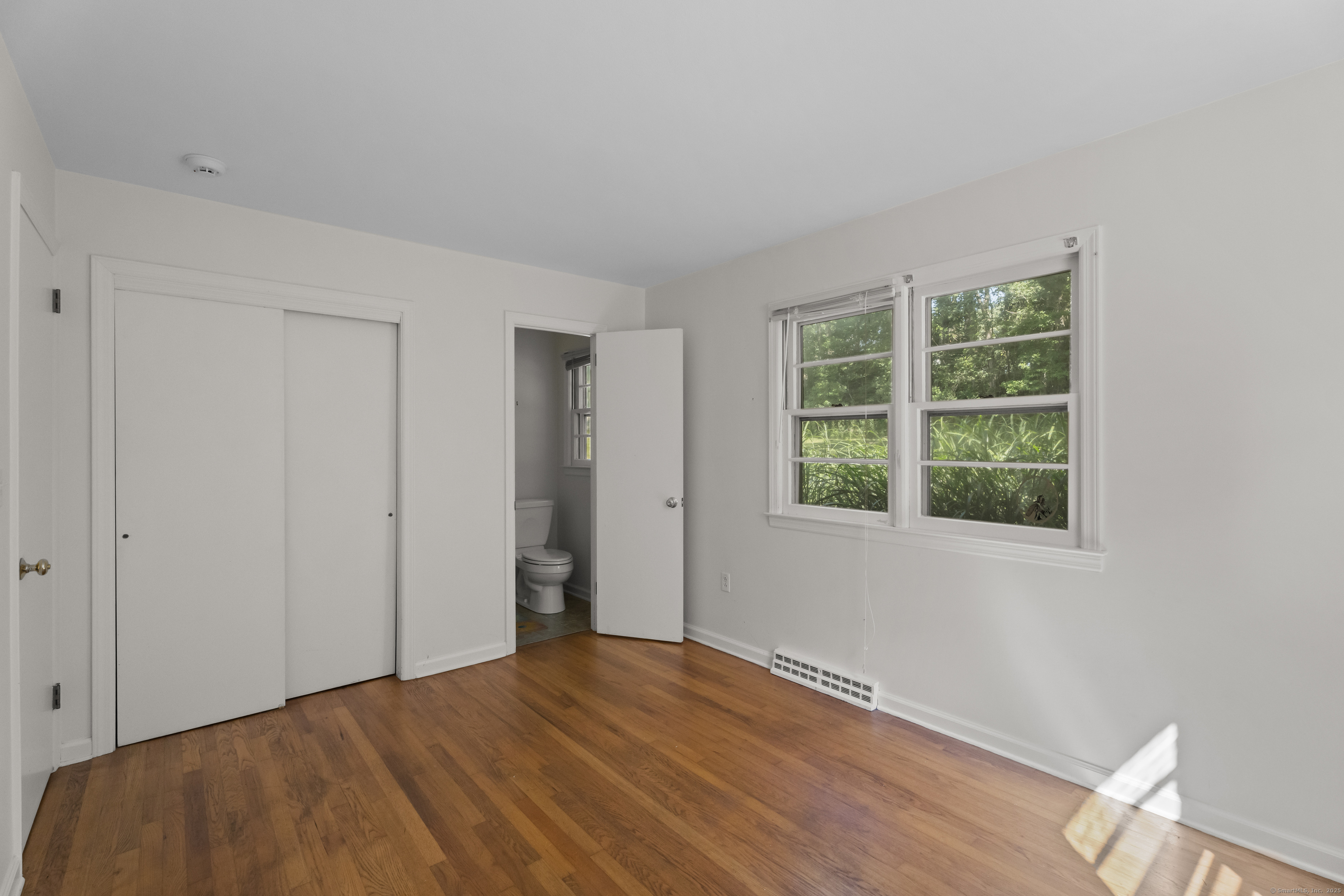 301 Osbrook Point Stonington, CT 06379 - Photo 24 of 39 a view of an empty room with wooden floor and a window