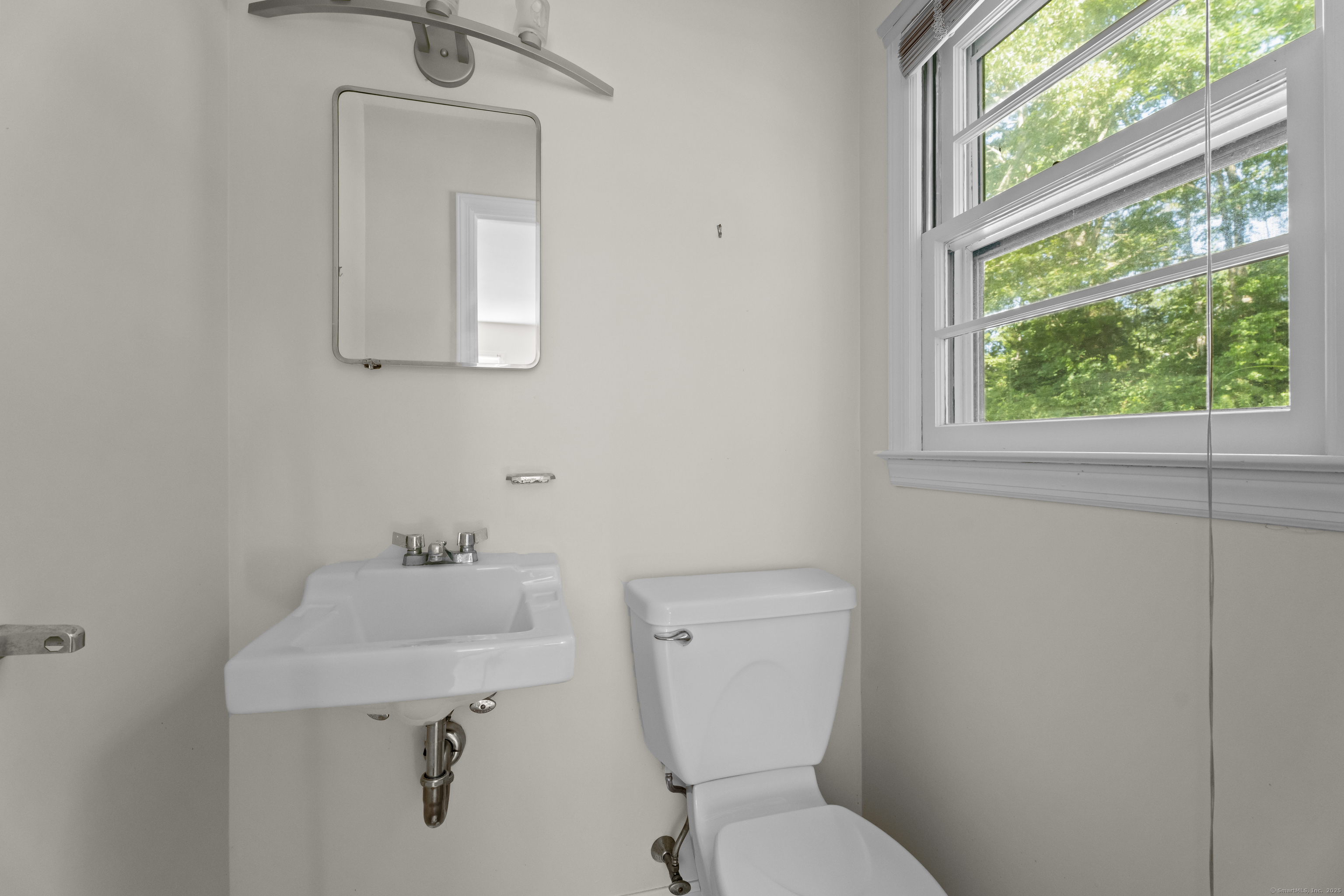 301 Osbrook Point Stonington, CT 06379 - Photo 25 of 39 a white toilet sitting next to a bathroom sink