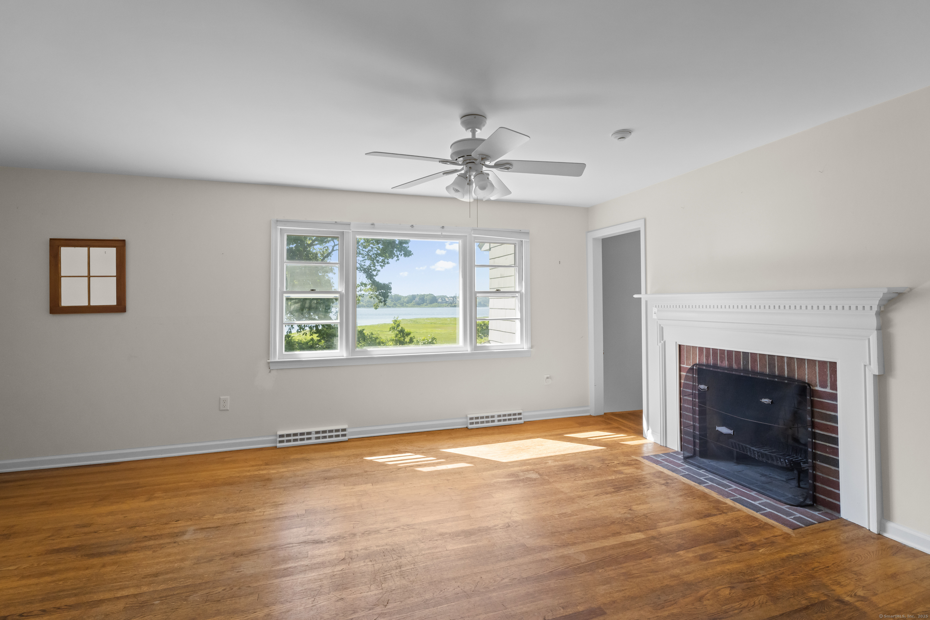 301 Osbrook Point Stonington, CT 06379 - Photo 26 of 39 an empty room with windows and fireplace