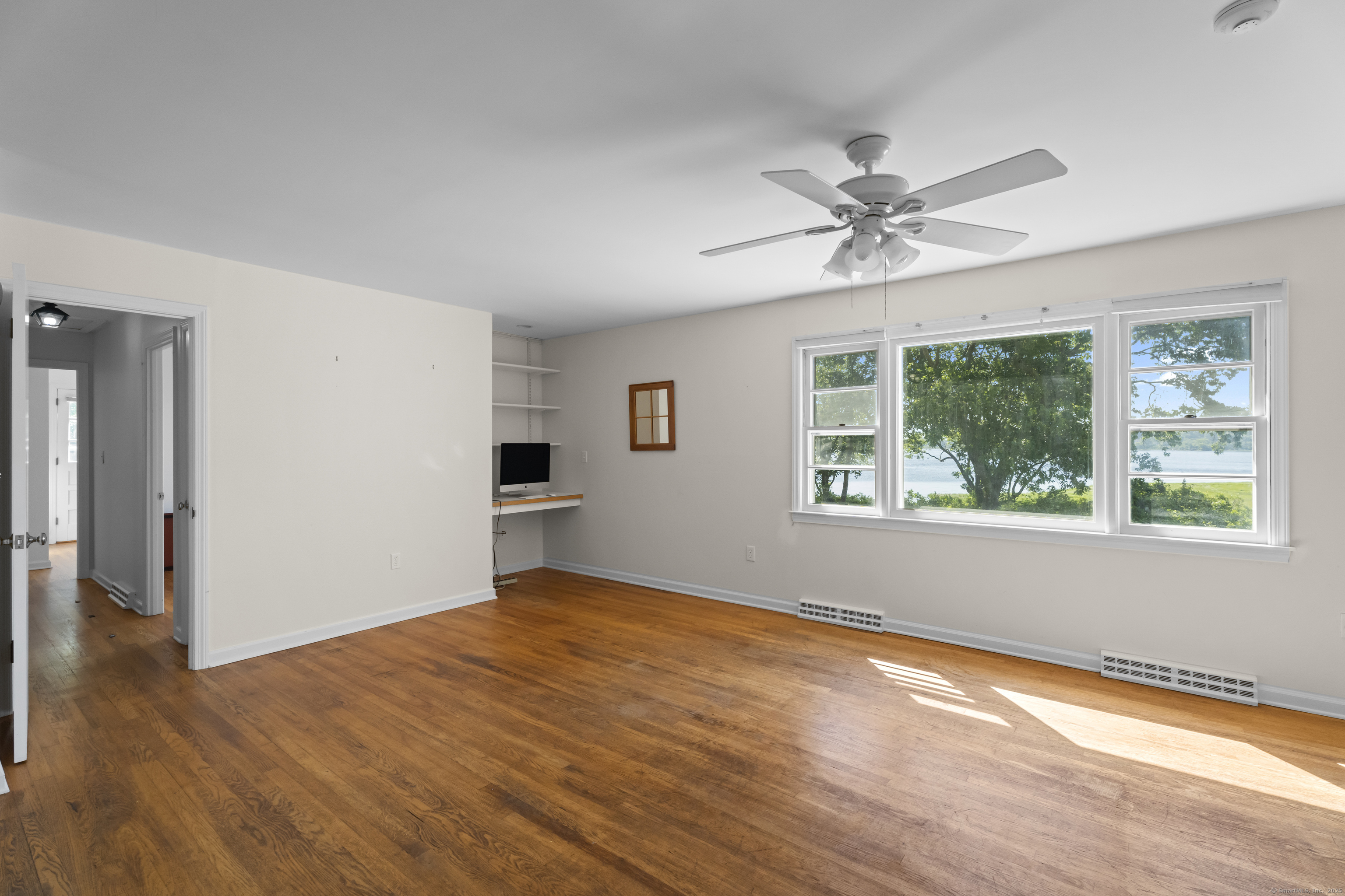 301 Osbrook Point Stonington, CT 06379 - Photo 27 of 39 a view of empty room with wooden floor and fan