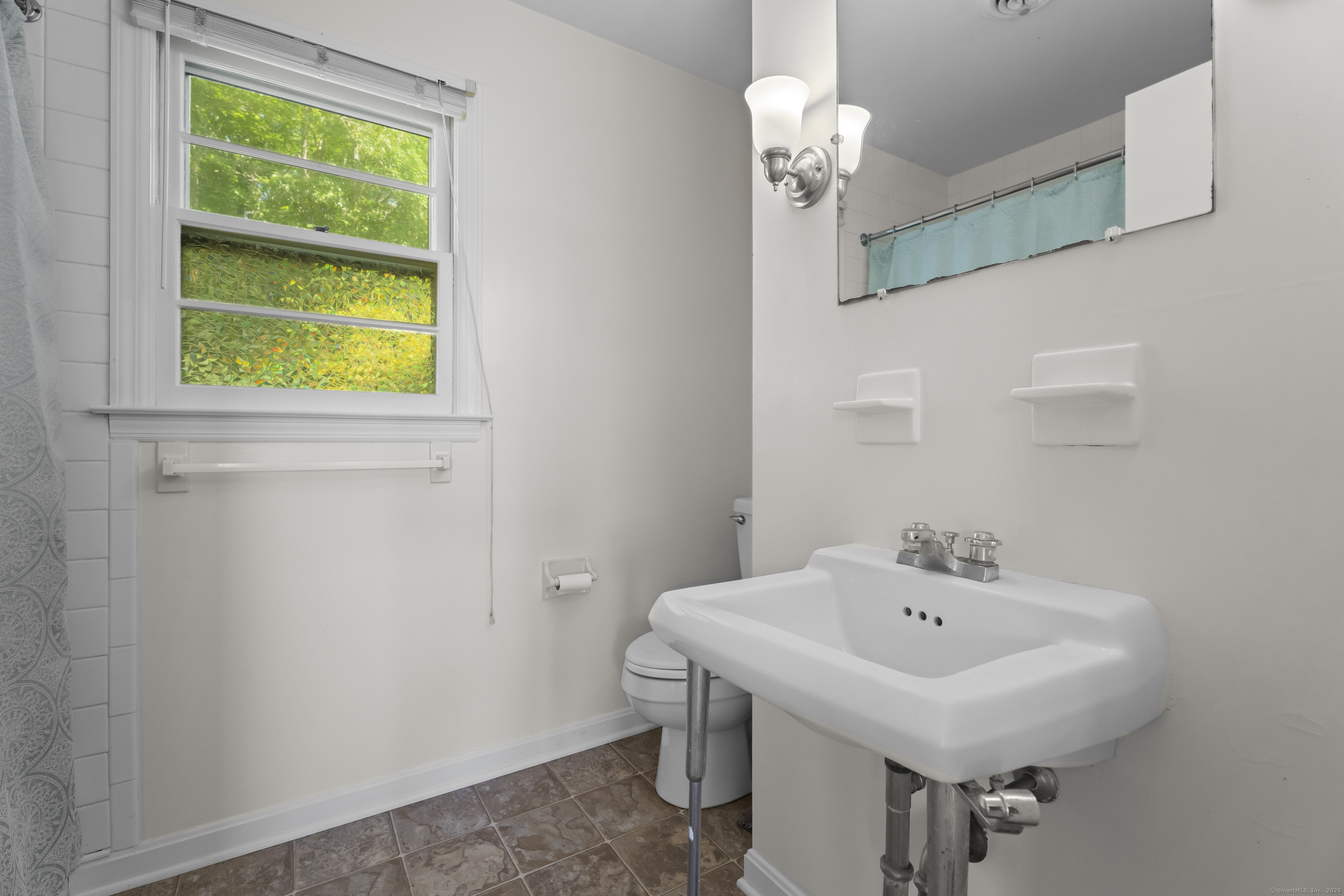 301 Osbrook Point Stonington, CT 06379 - Photo 30 of 39 a bathroom with a sink and a window