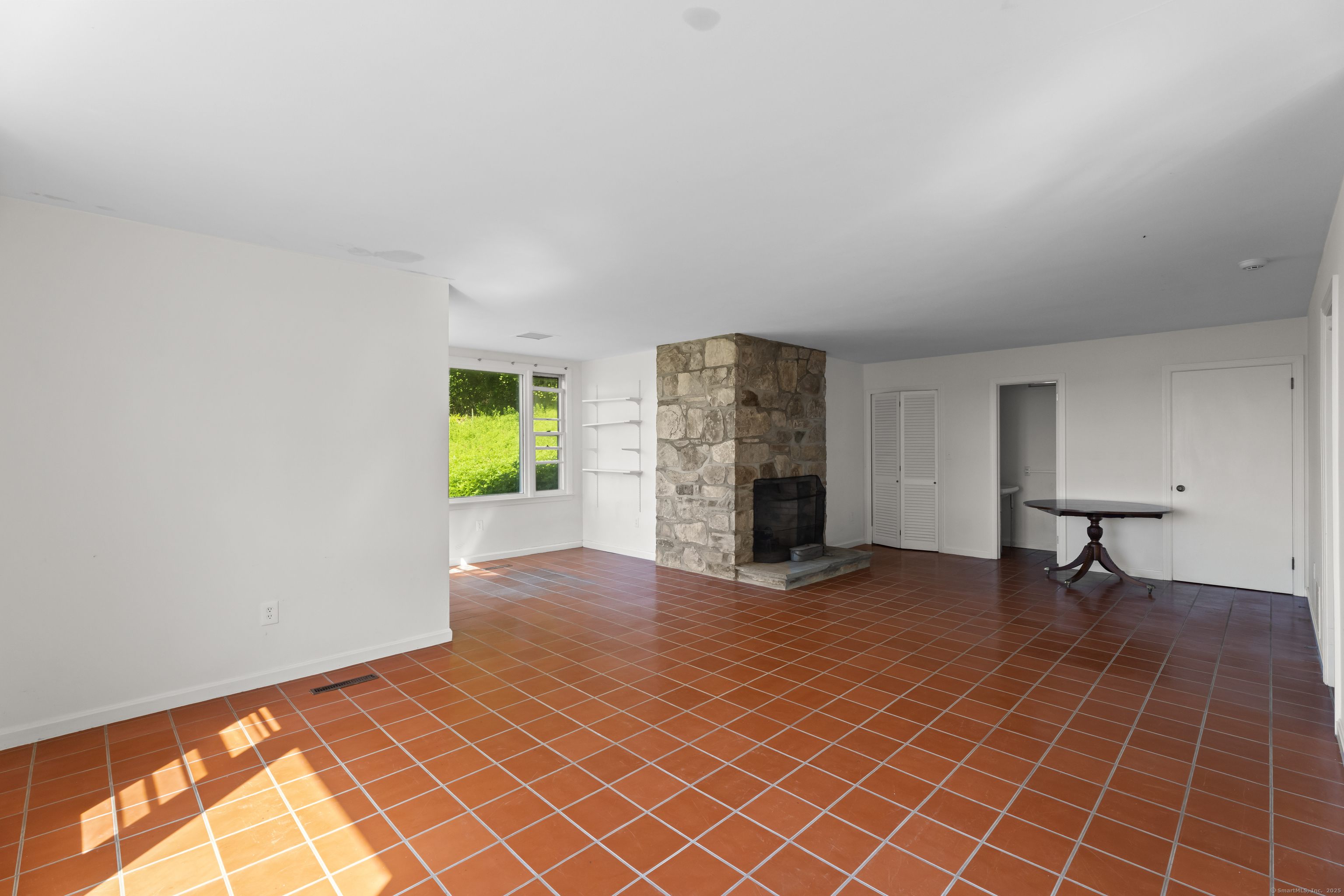 301 Osbrook Point Stonington, CT 06379 - Photo 31 of 39 an empty room with furniture and a fireplace