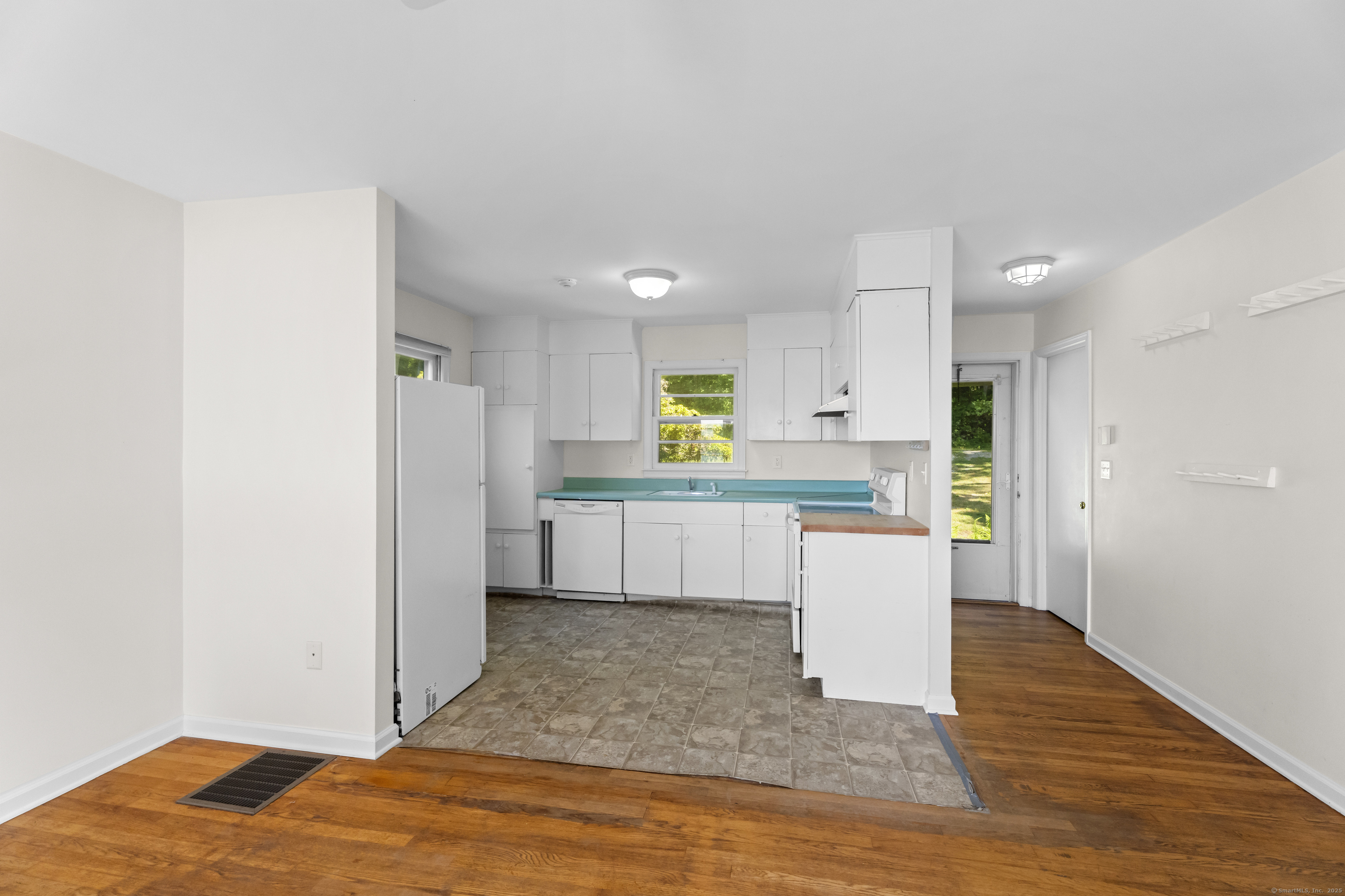301 Osbrook Point Stonington, CT 06379 - Photo 32 of 39 a kitchen with a refrigerator and a stove top oven