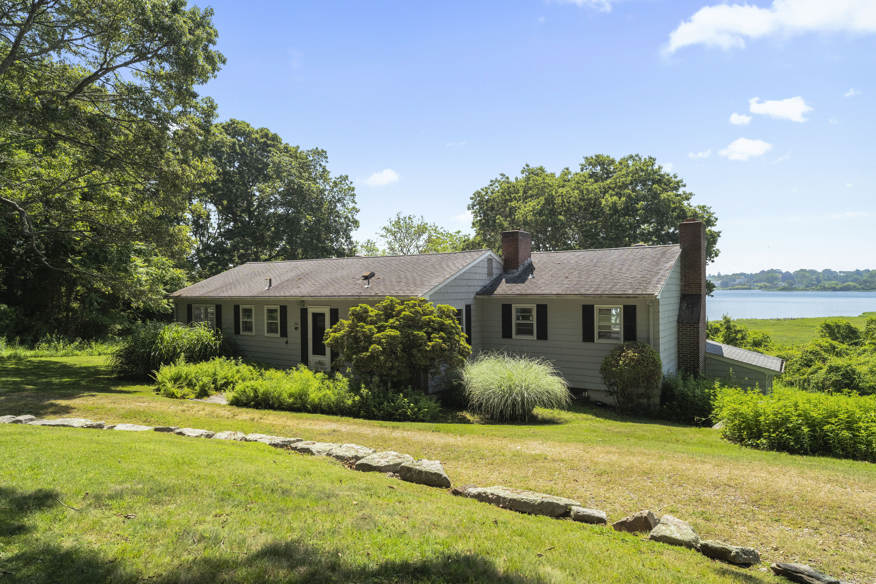 301 Osbrook Point Stonington, CT 06379 - Photo 37 of 39 a front view of a house with garden