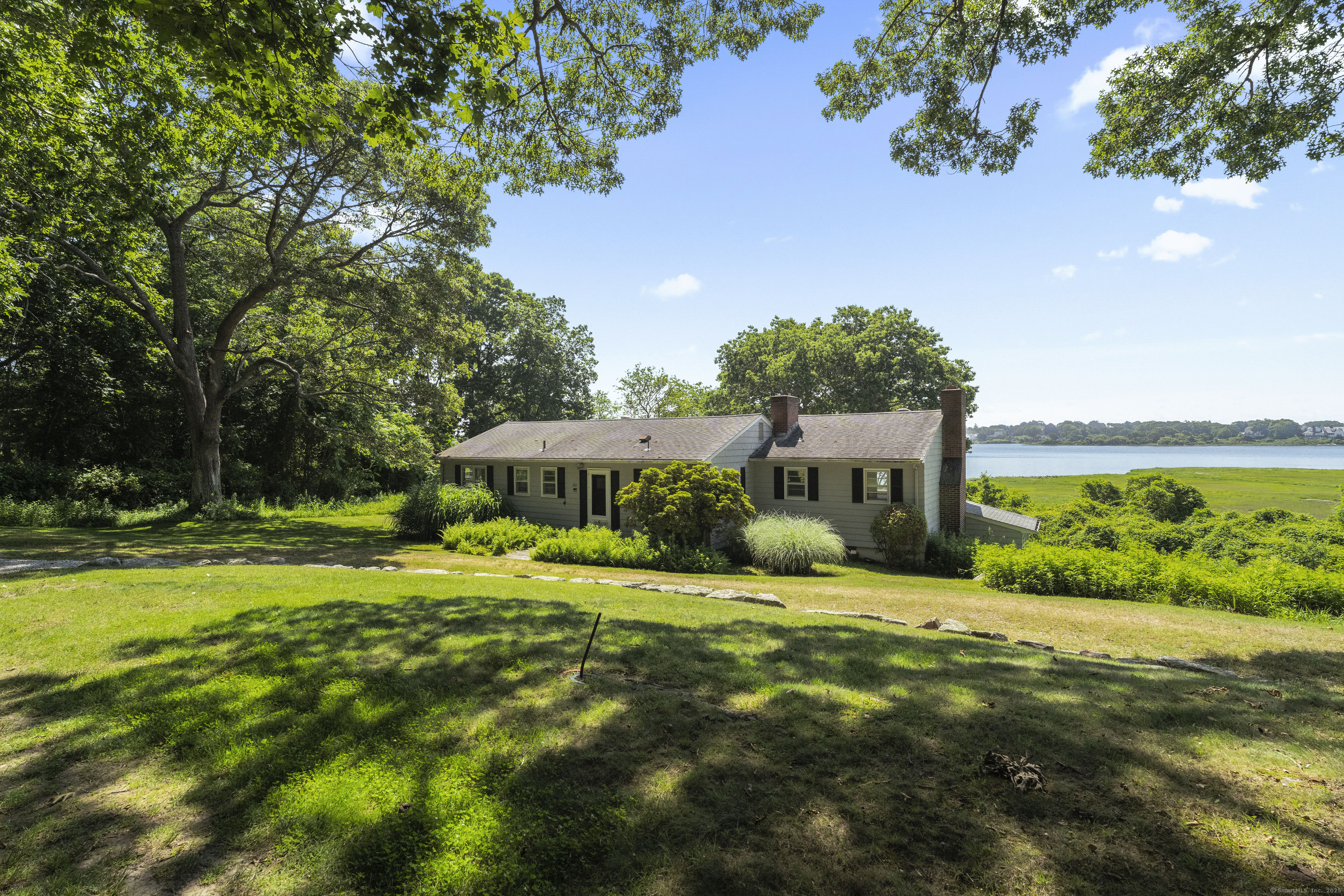 301 Osbrook Point Stonington, CT 06379 - Photo 4 of 39 a front view of a house with a yard