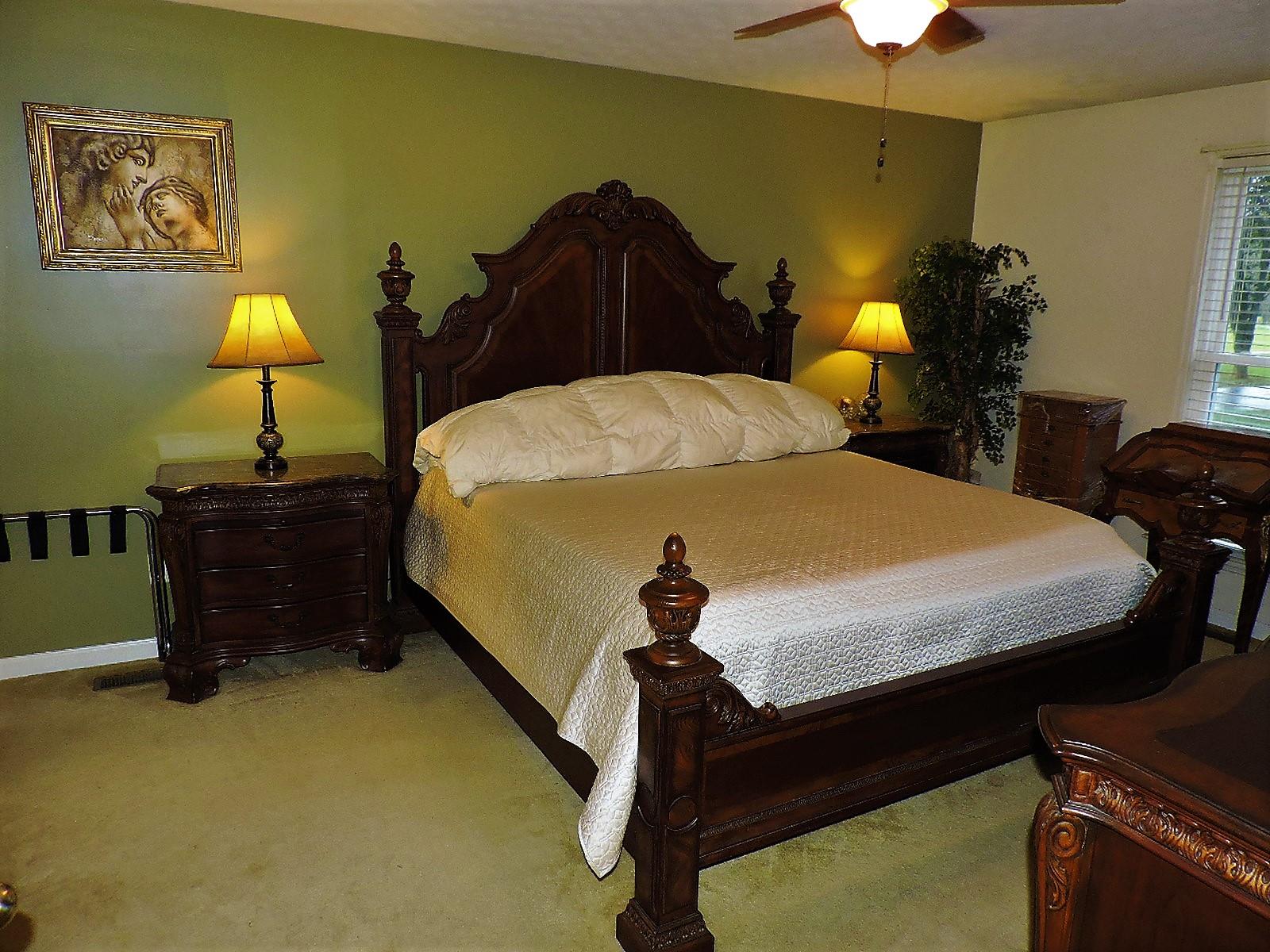 424 Goshen Road Lebanon, TN 37087 - Photo 21 of 29 a bed sitting in a bedroom next to a lamp