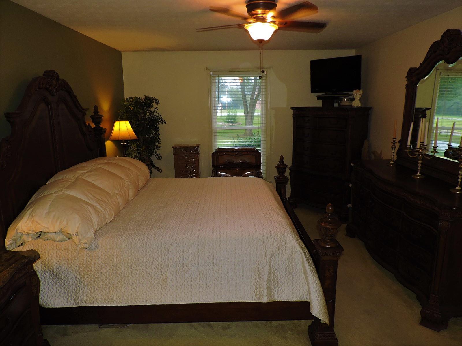 424 Goshen Road Lebanon, TN 37087 - Photo 22 of 29 a bedroom with a bed and a chandelier