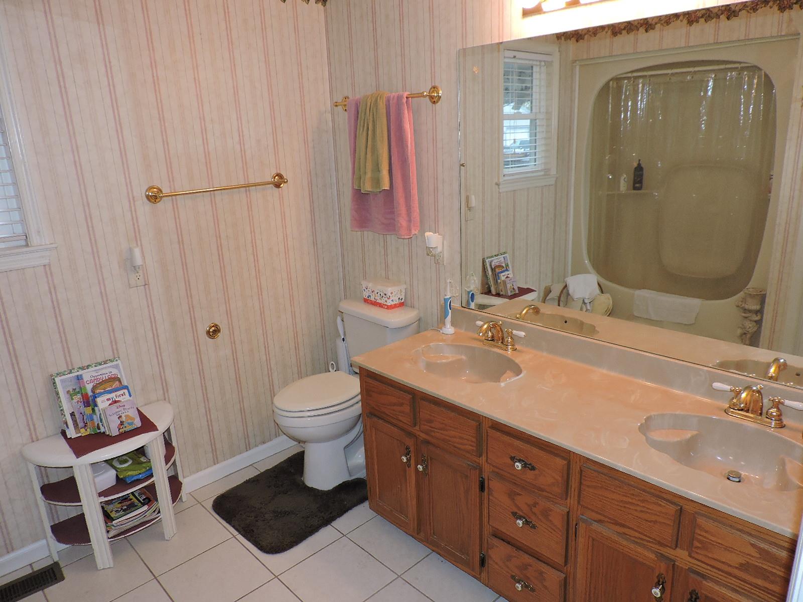 424 Goshen Road Lebanon, TN 37087 - Photo 23 of 29 a bathroom with a double vanity sink a toilet and a mirror