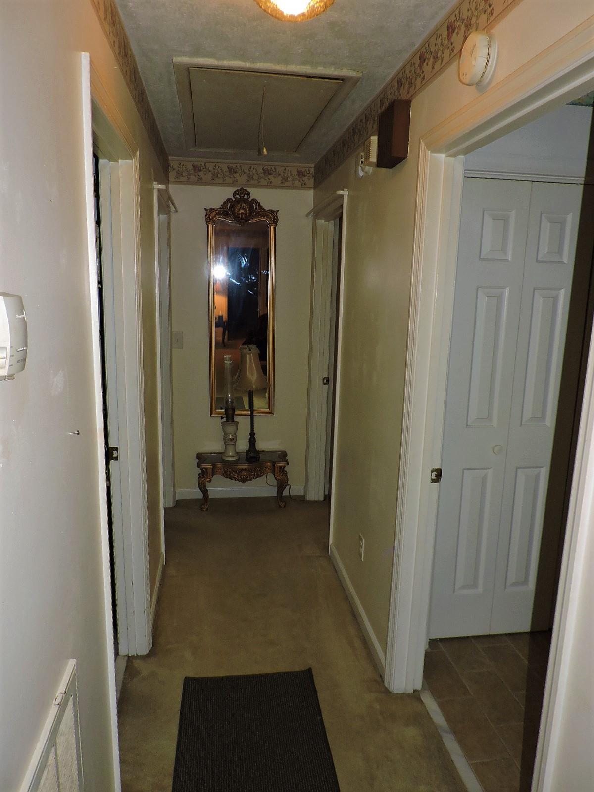 424 Goshen Road Lebanon, TN 37087 - Photo 29 of 29 a view of a hallway with wooden floor and a bathroom