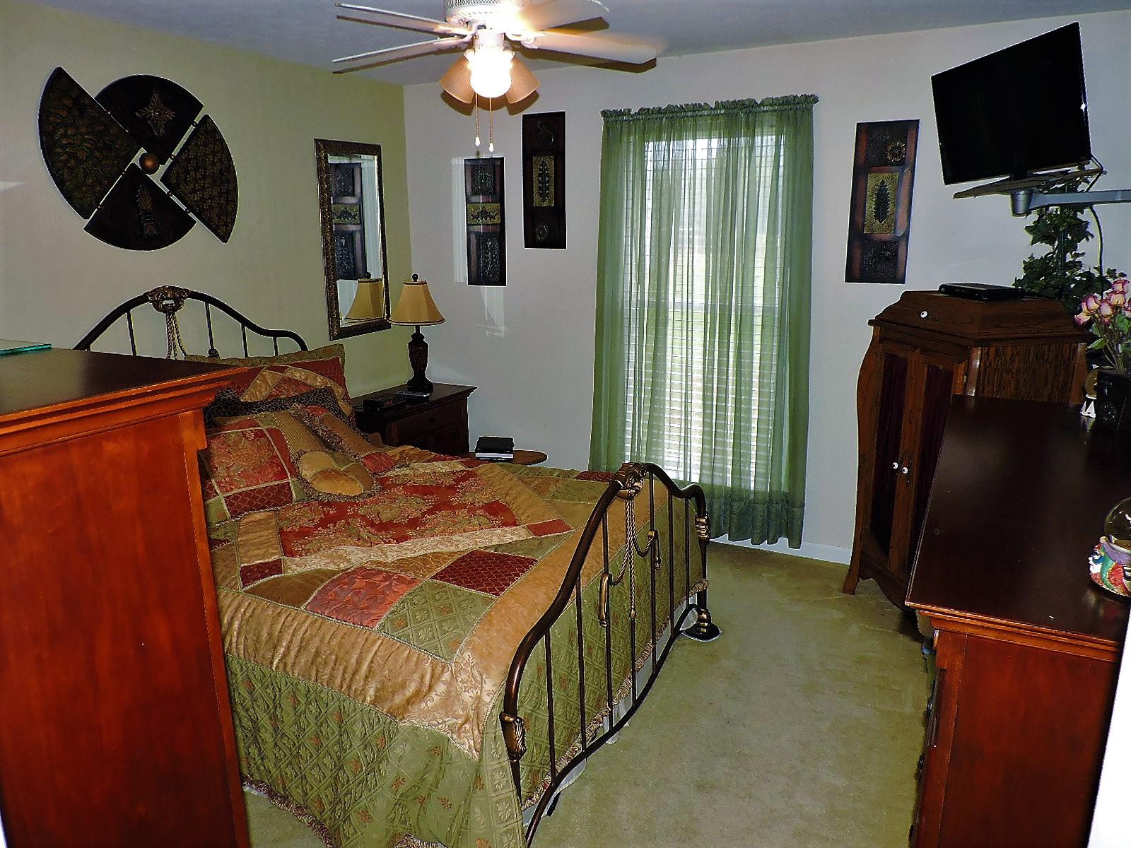 424 Goshen Road Lebanon, TN 37087 - Photo 28 of 29 a bedroom with a bed and a flat tv screen
