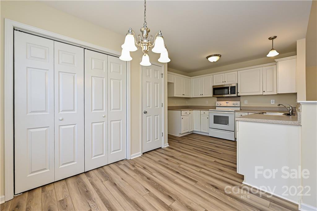 517 Kittiewake Lane Clover, SC 29710 - Photo 11 of 30 a kitchen with stainless steel appliances granite countertop a refrigerator a sink dishwasher a stove and white cabinets with wooden floor