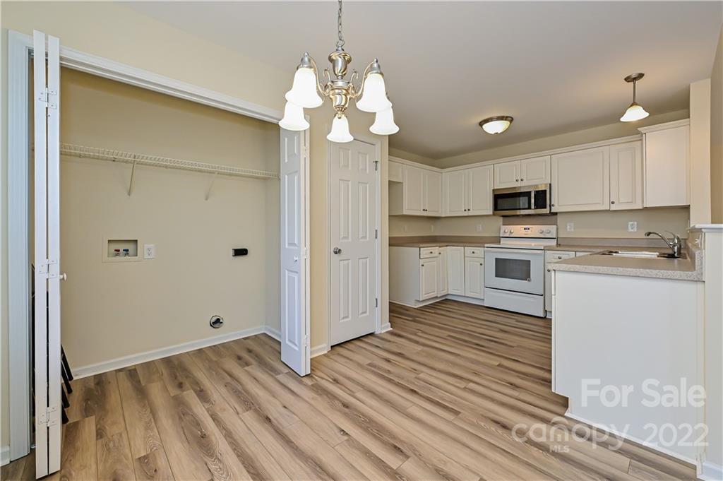 517 Kittiewake Lane Clover, SC 29710 - Photo 12 of 30 a kitchen with stainless steel appliances granite countertop a refrigerator a sink dishwasher a stove and white cabinets with wooden floor