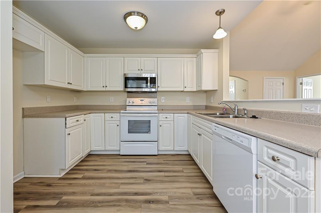 517 Kittiewake Lane Clover, SC 29710 - Photo 13 of 30 a large kitchen with cabinets stainless steel appliances a sink and a window