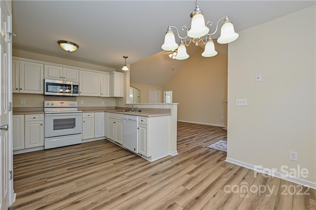 517 Kittiewake Lane Clover, SC 29710 - Photo 16 of 30 a kitchen with a sink cabinets stainless steel appliances and a chandelier
