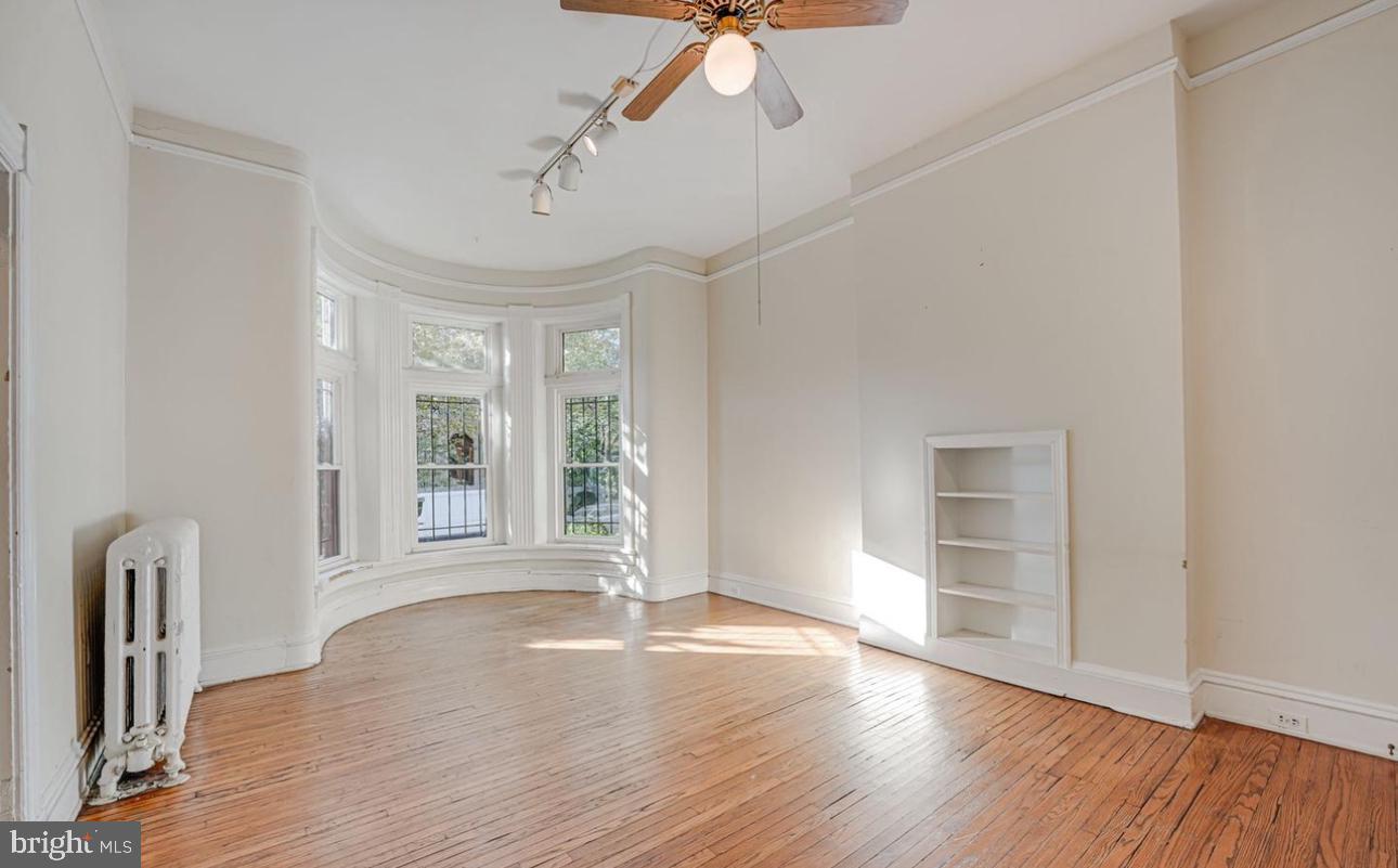 1703 Q Street Northwest Washington, DC 20009 - Photo 2 of 4 a view of empty room with wooden floor and fan