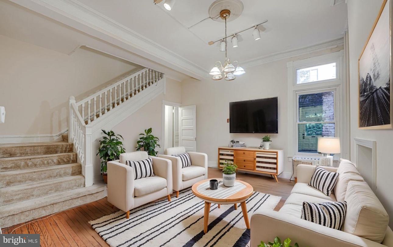 1703 Q Street Northwest Washington, DC 20009 - Photo 3 of 4 a living room with furniture chandelier and a flat screen tv